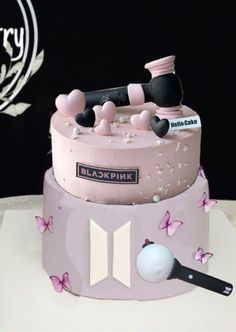 there is a pink cake with butterflies on it and the words blokpink