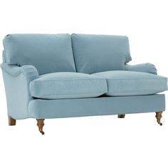 a light blue couch sitting on top of a white floor