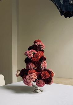 a bunch of flowers sitting on top of a white table