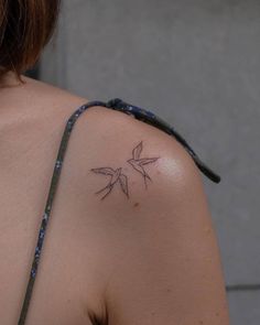 a woman with a small tattoo on her shoulder