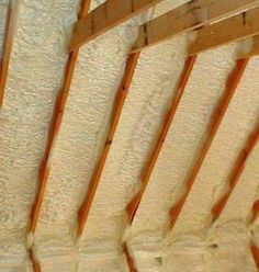 an unfinished ceiling with wooden beams and white paint on the walls, in a room that is being remodeled