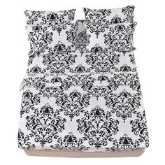 black and white bedding with an ornate design on the pillowcase, along with two pillows