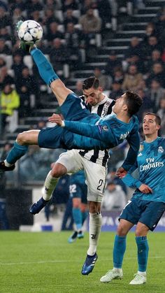 two soccer players colliding for the ball in front of an opponent during a game