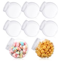 six clear plastic containers filled with candy and marshmallows next to each other