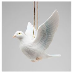 a white bird ornament hanging from a chain