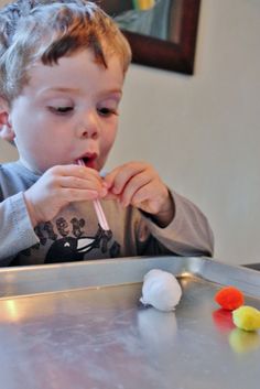 a little boy that is eating some kind of candy