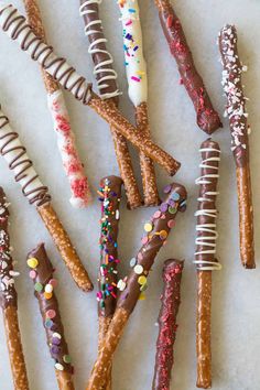 there are many different types of pretzels on the table with sprinkles