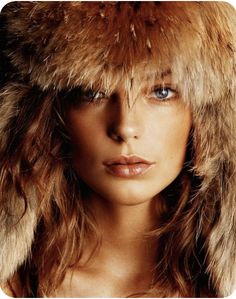 a woman wearing a fur hat and posing for the cover of skin magazine's latest issue