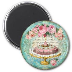 a cake with pink flowers on it is sitting in front of a blue background magnet