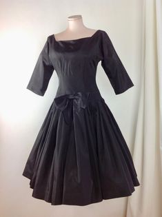 1950's Black Taffeta Cocktail Dress with a fitted bodice and a drop waist, a full pleated skirt, square cut-out neckline.. Wow. Such a beautiful dress!! There is a metal zipper that runs down the back of this dress for that perfect tailored hourglass fit. This garment is in EXCELLENT VINTAGE CONDITION. There are no stains, holes, repairs or snags. *There is no fashion label in this dress. There is a size label that is marked size 14.. lol.. ( of course this is sizing from the 1950's, and in toda Formal Dresses With Accordion Pleats And Full Skirt, Evening Dress With Accordion Pleats And Full Skirt, Formal Full Skirt Dress With Accordion Pleats, Accordion Pleated Full Skirt Party Dress, Full Skirt Dress With Accordion Pleats For Party, Classic Fitted Dress With Accordion Pleats, Fitted Square Neck Dress With Gathered Skirt, Fitted Black Dresses With Accordion Pleats, Black 1950s Style Wedding Dress