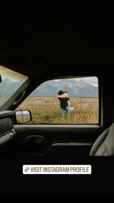 a person taking a photo in the back seat of a car