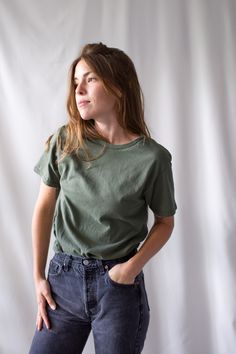 "The softest cotton crewneck tee shirt, worn here with models' own vintage jeans. I assume that this tee is made more recently* Maker: Delta Pro-Weight | Made in Honduras Material: 100% Cotton Condition: Excellent. Washed Deadstock. SMALL Shoulders: 16\" | Chest: 17.5\" | Length: 28\" | Sleeve: 6.5\" MEDIUM Shoulders: 18.5\" | Chest: 19.5\" | Length: 29\" | Sleeve: 7.5\" Hanna is 5'3\" and wears a modern small. She shows the SMALL in the first two photos and medium in remaining photos. To see mo Womens Basic Tee, Capsule Wardrobe Essentials, Jean Vintage, Beauty Clothes, Womens Basic, Green Cotton, Vintage Jeans, Honduras, Piece Of Clothing