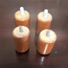 three brown wooden cylinders sitting on top of a table