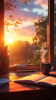 an open book and cup sit on a desk in front of a window with the sun setting