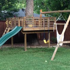 a wooden play set with swings, slide and hammock in the back yard