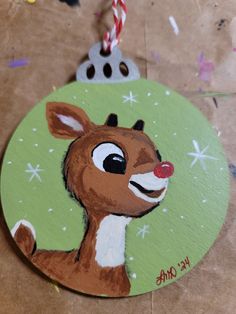 a christmas ornament with a deer painted on it