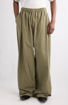 Balenciaga's outsized aesthetic informs the roomy proportions of relaxed pull-on pants fashioned from linden-colored cotton-canvas. Elastic waist Front slant pockets 100% cotton Dry clean Made in Italy Designer Clothing Relaxed Cotton Wide-leg Harem Pants, Oversized Cotton Wide Leg Pants, Relaxed Fit Wide Leg Parachute Pants, Baggy Khaki Wide Leg Cotton Pants, Baggy Cotton Wide Leg Pants In Khaki, Oversized Wide Leg Cotton Pants, Baggy Khaki Wide Leg Pants With Elastic Waistband, Baggy Cotton Harem Pants, Oversized Green Wide-leg Pants