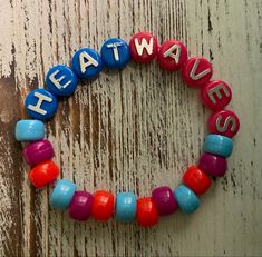 a colorful beaded bracelet with the words heat waves written in different colors on it