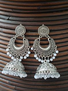 These are traditional pakistani/indian oxidized silver chand bali earings jhumka earrings  You will absolutely fall in love with this vintage inspired piece of jewelry. These earings can be used on any occasion or you can bring these earings in everyday use. At Nooritrendz we are striving to provide one on one communication and great customer service to all who wish to contact us. Customer's satisfaction is our priority.  You will get same product as we showcased in our listing.our high quality product will not leave you unsatisfied. Visit our shop and like 👍 💕 it to get regular updates https://www.etsy.com/ca/shop/nooritrendz Bohemian Silver Bridal Earrings With Latkans, Bohemian Bridal Earrings With Latkans In Silver, Bohemian Bridal Silver Earrings With Latkans, Silver Bohemian Style Drop Jhumkas, Bohemian Chandbali Bridal Earrings In Silver, Silver Bohemian Chandbali Bridal Earrings, White Bohemian Earrings For Diwali, Bohemian White Earrings For Diwali, Silver Oxidized Finish Chandbalis