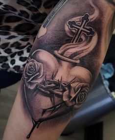 a tattoo with roses and a cross on it