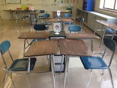 an empty classroom with desks and chairs