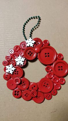 a red button wreath with white snowflakes on it