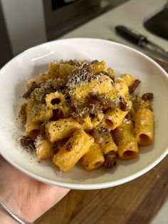 a white bowl filled with pasta covered in sauce