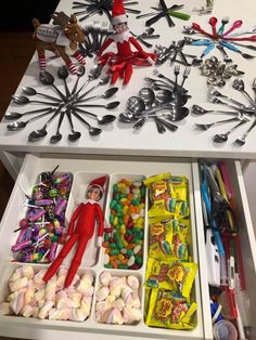 the elf in the kitchen is organized with candy and spoons