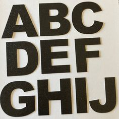 the letters are black and white with some type of lettering on them that read abc, defi, j