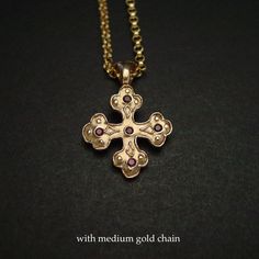 "Hand sculpted orthodox cross pendant with embedded garnet. The orthodox cross is a variation of the Christian cross since the 6th century in the Byzantine Empire. This is a square cross with clover tip shape ends. A cross with three circles or discs on each arm in a Christian context represents the Holy Trinity but was probably also copied from earlier Celtic Druidry, where the circles or rings represent the three dominions of earth, sky and sea. - Hand carved solid yellow bronze also called je Greek Orthodox Cross, Orthodox Cross Necklace, Medieval Cross, Byzantine Cross, The Byzantine Empire, Byzantine Jewelry, Sky And Sea, Orthodox Cross, The Holy Trinity