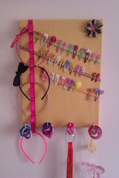 a bulletin board with lots of hair accessories hanging on it