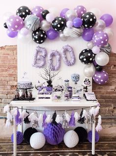 a table with balloons and decorations on it