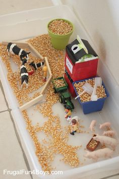 a bunch of toys that are sitting on a table in front of some food items