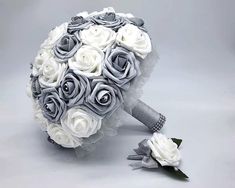 a bridal bouquet with grey and white roses