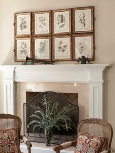 a living room filled with furniture and a fire place covered in framed pictures on the wall