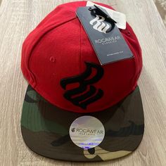 Rocawear Men’s Hat In Red ,Black And The Front Part In Camo Color Nwt Casual Red Fitted Hat For Streetwear, Casual Red Baseball Cap For Streetwear, Casual Winter Snapback Hat For Streetwear, Red Curved Bill Fitted Hat, Casual Red Fitted Hat With Curved Bill, Casual Fitted Hat With Flat Bill For Winter, Casual Winter Fitted Hat With Flat Bill, Casual Winter Snapback Hat With Flat Bill, Fitted Casual Snapback Hat For Sports