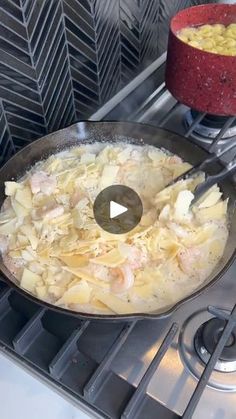 a frying pan filled with food on top of a stove next to a red bowl