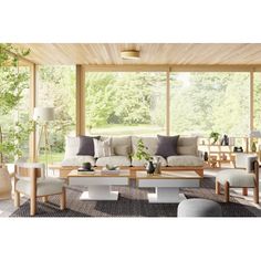 a living room filled with lots of furniture under a wooden ceiling covered in glass windows