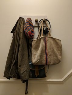 an assortment of purses hanging on a wall