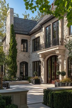 a large house with lots of windows and bushes