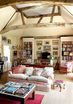 a living room filled with furniture and lots of books