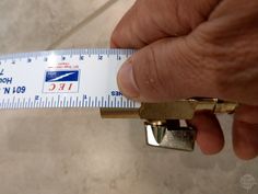 a person holding a measuring tape with a lock on it