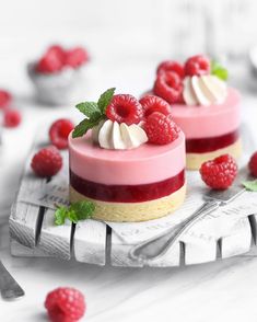 raspberry cheesecakes with whipped cream and fresh berries