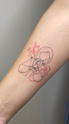 a woman's arm with a tattoo on it that has an image of a cartoon character