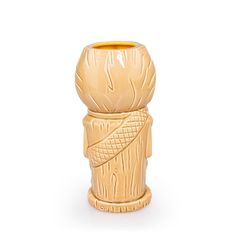 a small wooden vase with an intricate design