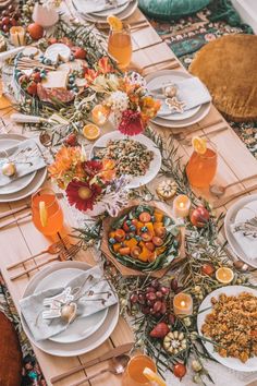 a long table is set with many plates and bowls