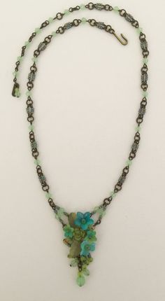 Petite delicate pendant style necklace with pretty mixed hues of green, turquoise and sea foam green. The flowers are hand painted and the entire necklace is beaded with thread and wire. Including the necklace itself. This is a nice style for a more petite body or someone who wants a necklace that is more delicate. This necklace would look great with a pretty summer dress or can be worn casually with even a pair of jeans. Earrings on the model are also available. This is a quality piece of jewel Turquoise Flower Charm Pendant Jewelry, Green Pendant Necklace With Flower Charm, Bohemian Turquoise Flower Necklace, Delicate Green Flower Pendant Jewelry, Dainty Green Flower Pendant Jewelry, Handmade Turquoise Flower Necklace, Turquoise Flower Necklace With Flower Charm, Green Flower Pendant Necklace As Gift, Green Pendant Jewelry With Lobster Clasp