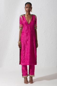 Hot pink silk kurta with a V neckline and trims on the sleeves. Comes with straight fit pant.
Components: 2
Pattern: Embroidery
Type Of Work: Zardozi and Sequin
Neckline: V neck
Sleeve Type: Half
Fabric: Silk
Color: Pink
Other Details: 
Pant with embroidered hems
Kurta with side slits
Occasion: Mehendi and Haldi - Aza Fashions Straight Kurti Designs, Pink Suits Women, Embroidery Zardozi, Kurta Pant Set, Simple Kurti Designs, Indian Dresses Traditional, Traditional Indian Outfits, Silk Kurta, Kurta Designs Women