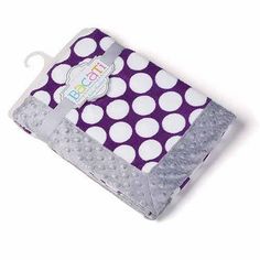 a purple and white polka dot baby blanket