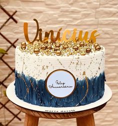 there is a cake that has been decorated with gold and blue